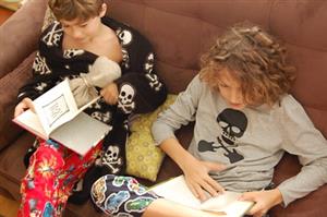 girl and boy reading on soft seating